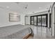 Large main bedroom with projector, modern art, and sliding glass doors to a patio at 324 Park Way, Las Vegas, NV 89106