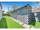 Outdoor storage shed surrounded by artificial grass and decorative stones at 324 Park Way, Las Vegas, NV 89106