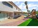 Expansive backyard featuring a covered patio, lush green lawn, and an inviting play area, ideal for outdoor enjoyment at 327 Fuente Dr, Henderson, NV 89014