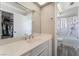 Bright bathroom featuring a marble tiled shower, tub, and white single sink vanity at 327 Fuente Dr, Henderson, NV 89014