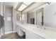 Modern bathroom featuring a double vanity, elegant countertops, ample lighting, and a separate shower for convenience at 327 Fuente Dr, Henderson, NV 89014