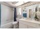 Clean and bright bathroom with a tub and shower, toilet, vanity, and decorative accents at 327 Fuente Dr, Henderson, NV 89014