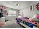 Cozy bedroom featuring gray walls, carpet, ceiling fan and a large window at 327 Fuente Dr, Henderson, NV 89014