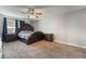 Spacious primary bedroom featuring a ceiling fan, plush carpet, and matching dark wood furniture at 327 Fuente Dr, Henderson, NV 89014
