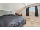 Comfortable bedroom featuring a dark bedset, sloped ceiling, dark curtains, and neutral walls at 327 Fuente Dr, Henderson, NV 89014