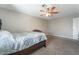 Carpeted bedroom with a ceiling fan and neutral walls, providing a cozy atmosphere at 327 Fuente Dr, Henderson, NV 89014