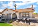 Charming single-story home featuring a Spanish tile roof, stucco walls, and a cozy front patio area at 327 Fuente Dr, Henderson, NV 89014