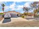 Exterior elevation of home featuring an attached two car garage and desert landscaping at 327 Fuente Dr, Henderson, NV 89014