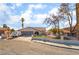 Charming single-story home showcasing a well-maintained front yard, two car garage, and inviting curb appeal at 327 Fuente Dr, Henderson, NV 89014