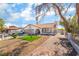 Inviting single-story home featuring an elegant brick driveway, manicured lawn, and a cozy outdoor seating area at 327 Fuente Dr, Henderson, NV 89014