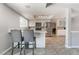 Modern kitchen featuring sleek stainless steel appliances, tile flooring, a breakfast bar, and ample natural light at 327 Fuente Dr, Henderson, NV 89014