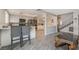 Open-concept kitchen with a breakfast bar, white cabinets, and stainless steel appliances at 327 Fuente Dr, Henderson, NV 89014