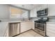 Bright kitchen with quartz countertops, stainless steel appliances, and tile flooring at 327 Fuente Dr, Henderson, NV 89014