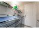 This laundry room features tile floors and a stacked washer and dryer at 327 Fuente Dr, Henderson, NV 89014