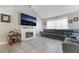 Cozy living room featuring a charming fireplace, tile flooring, and a comfortable seating area perfect for relaxation at 327 Fuente Dr, Henderson, NV 89014