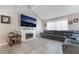 Bright living room featuring tile flooring, a brick fireplace, and a large wall-mounted TV at 327 Fuente Dr, Henderson, NV 89014