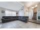 Open-concept living room with a high ceiling, tile flooring, and a large sectional sofa at 327 Fuente Dr, Henderson, NV 89014