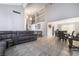 Spacious living room showcasing high ceilings, tile flooring, and an adjacent dining area perfect for entertaining at 327 Fuente Dr, Henderson, NV 89014