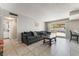 Cozy living room with tile flooring, comfortable seating, and a sliding glass door to the backyard at 327 Fuente Dr, Henderson, NV 89014