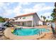 Backyard view of this house featuring a pool, hot tub and mature landscaping at 327 Fuente Dr, Henderson, NV 89014