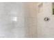 Shower displaying white marble-like tiles, niche, and modern hardware, creating a spa-like experience at 327 Fuente Dr, Henderson, NV 89014