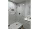 Modern bathroom featuring a marble tiled shower with a built-in shelf and updated fixtures at 335 W Basic Rd, Henderson, NV 89015