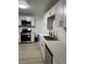 Updated kitchen featuring stainless steel appliances and bright white cabinets with modern hardware at 335 W Basic Rd, Henderson, NV 89015