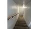 Carpeted staircase featuring a wooden handrail for added safety and convenience when navigating between floors at 335 W Basic Rd, Henderson, NV 89015