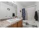 Bathroom featuring a granite countertop, sink, toilet, shower with blue curtain, and bronze hardware at 3495 Eagle Bend St, Las Vegas, NV 89122