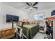 Well-lit bedroom with a comfortable bed, ceiling fan, and dedicated workspace for convenience and relaxation at 3495 Eagle Bend St, Las Vegas, NV 89122
