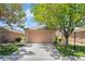 Charming single-story home with a two-car garage, lush lawn and mature trees enhancing curb appeal at 3495 Eagle Bend St, Las Vegas, NV 89122
