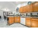 Kitchen space with tile countertops, white dishwasher, and view of dining area at 3495 Eagle Bend St, Las Vegas, NV 89122