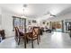 Open-concept living and dining area with tile flooring, vaulted ceilings, and access to the backyard pool at 3495 Eagle Bend St, Las Vegas, NV 89122
