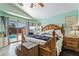 This bedroom features a large bed, access to the backyard pool area, and plenty of natural light at 3495 Eagle Bend St, Las Vegas, NV 89122