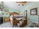 Tranquil main bedroom with a raised platform bed, ceiling fan, and a calming color scheme for relaxation at 3495 Eagle Bend St, Las Vegas, NV 89122
