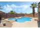 Backyard oasis featuring a pool, spa, mature palm trees, and privacy fencing for a relaxing atmosphere at 3495 Eagle Bend St, Las Vegas, NV 89122
