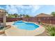 Backyard pool and spa featuring a waterfall, mature landscaping, and privacy fencing at 3495 Eagle Bend St, Las Vegas, NV 89122