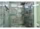 Walk-in shower with decorative tile, rainfall shower head, and built-in niche providing a spa-like experience at 3495 Eagle Bend St, Las Vegas, NV 89122