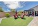 Lush backyard with artificial grass, a patio, and elegant outdoor seating, perfect for relaxing and enjoying the outdoors at 4523 Herbert River Ave, Las Vegas, NV 89141