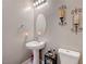 Small bathroom featuring a pedestal sink and a decorative mirror at 4523 Herbert River Ave, Las Vegas, NV 89141