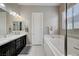 Clean bathroom featuring a soaking tub and granite countertops at 4523 Herbert River Ave, Las Vegas, NV 89141