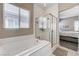 Elegant bathroom displaying a soaking tub with a separate glass shower enclosure at 4523 Herbert River Ave, Las Vegas, NV 89141
