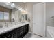 Bathroom showcasing granite countertops, soaking tub, and modern fixtures at 4523 Herbert River Ave, Las Vegas, NV 89141