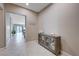 Inviting foyer featuring tile floors, a cabinet for storage, and an open view to the rest of the home at 4523 Herbert River Ave, Las Vegas, NV 89141