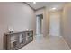 Bright entry foyer boasts tile flooring, storage cabinet, and neutral paint scheme at 4523 Herbert River Ave, Las Vegas, NV 89141