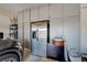 Organized garage with ample storage cabinets, stainless steel refrigerator, and parking space for a vehicle at 4523 Herbert River Ave, Las Vegas, NV 89141