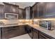 Beautiful kitchen with modern appliances, granite countertops, and sleek dark cabinetry at 4523 Herbert River Ave, Las Vegas, NV 89141