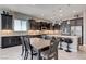 Modern kitchen features granite countertops, stainless appliances, and dark wood cabinetry at 4523 Herbert River Ave, Las Vegas, NV 89141