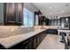 Lovely kitchen with granite countertops, stainless steel appliances, and stylish dark cabinetry at 4523 Herbert River Ave, Las Vegas, NV 89141