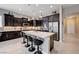 Gourmet kitchen with granite island, stainless steel appliances, and sleek dark cabinets at 4523 Herbert River Ave, Las Vegas, NV 89141